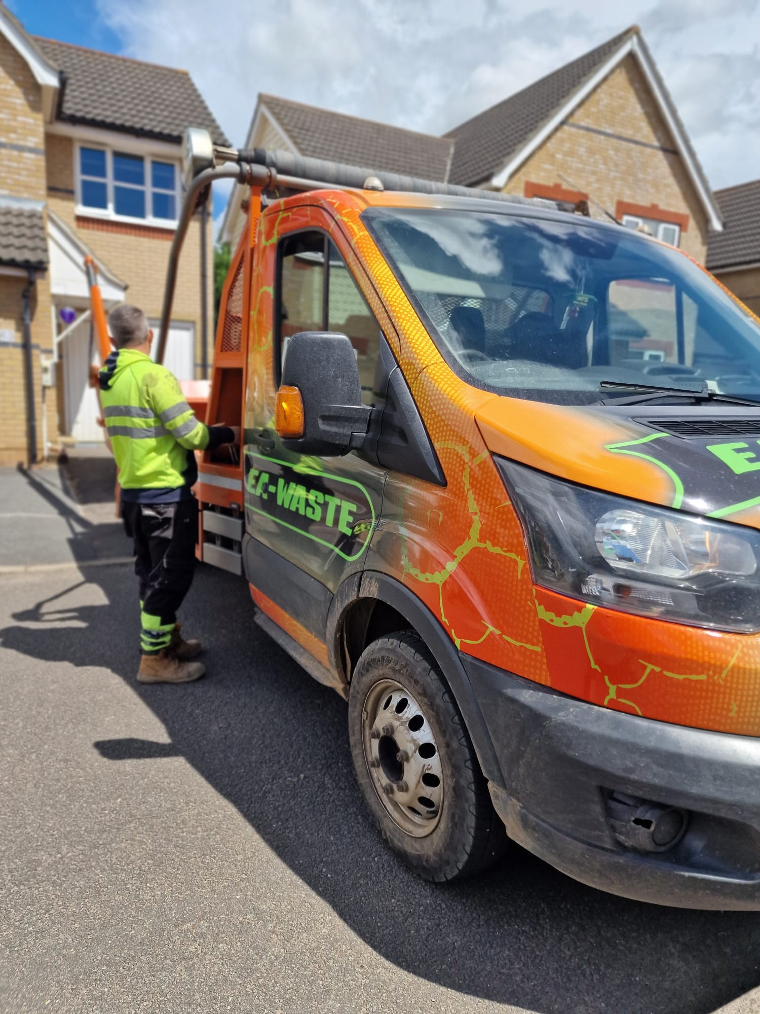 An EA Waste skip hire truck parked on a sunny day, ready for waste management and skip delivery in Colchester.