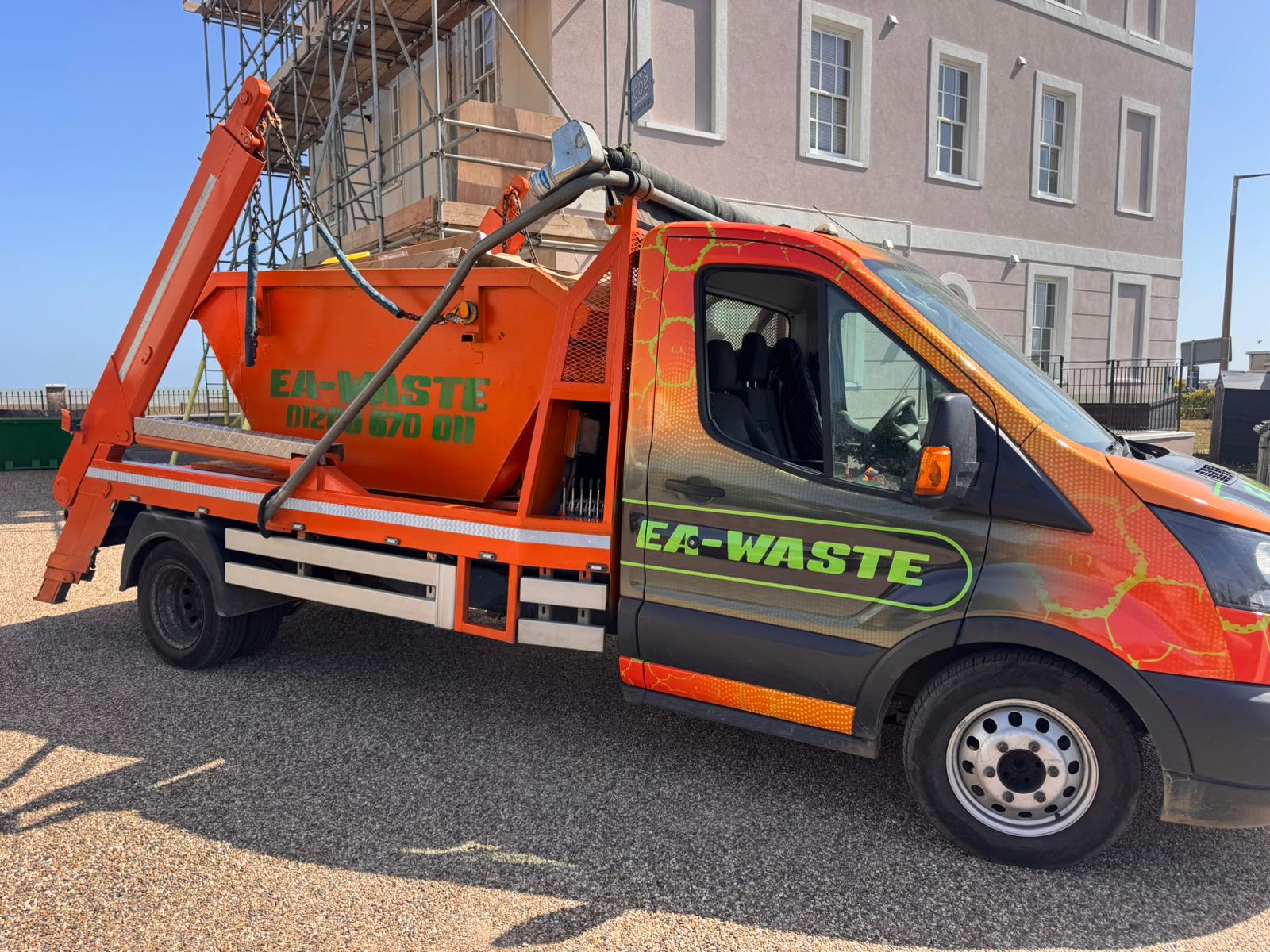An EA Waste van delivering a 4-yard skip to Colchester on a driveway